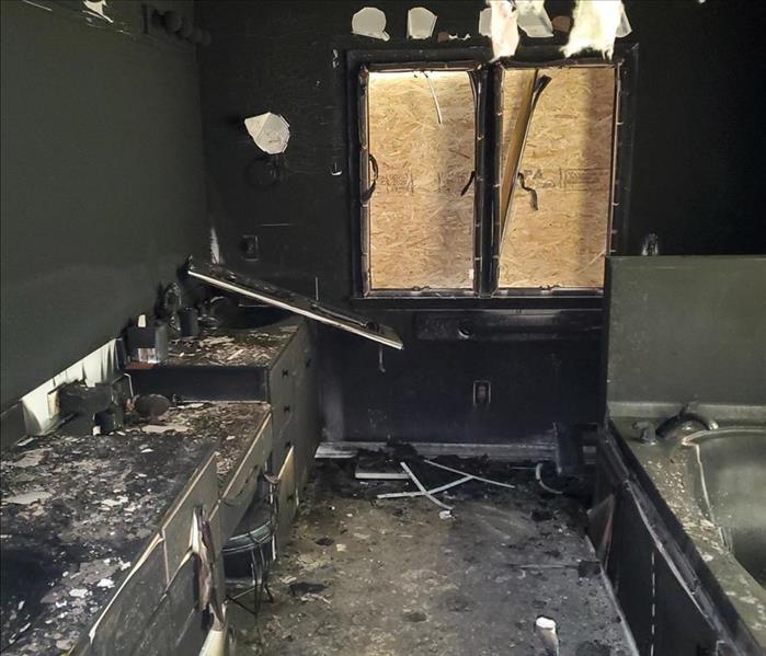 fire destroyed bathroom, black walls, boarded window
