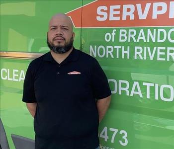 Crew member in front of service truck 