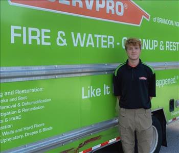 SERVPRO employee in front of service truck.