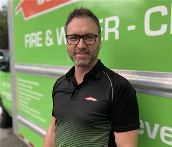 Man standing in front of green SERVPRO truck