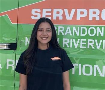 Employee in front of service trucks